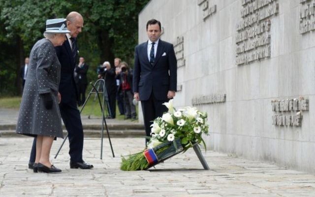 La Reine d'Angleterre Elizabeth II et le duc d'Edimbourg, le prince Philip  déposent une couronne de fleurs lors d'une visite au mémorial de l'ancien camp de concentration nazi de Bergen-Belsen, le 26 juin 2015. (Crédit : AFP PHOTO / POOL / JULIAN Stratenschulte)