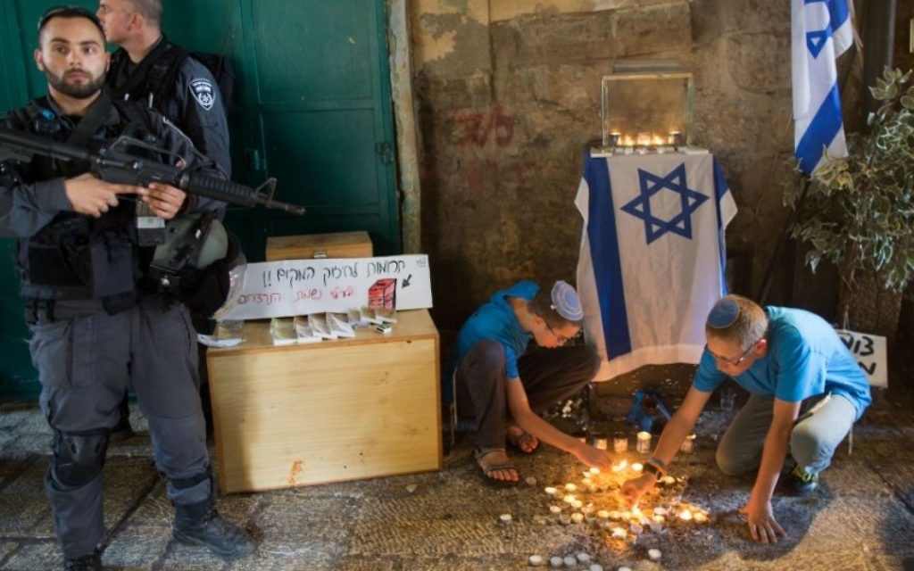 Des adolescents juifs allument des bougies en forme d'étoile de David sur le site de l'attaque de coup de poignard de la semaine dernière dans le quartier musulman de la Vieille Ville de Jérusalem, le 8 octobre, 2015 (Crédit : Yonatan Sindel / Flash90) Des adolescents juifs allument des bougies en forme d'étoile de David sur le site de l'attaque de coup de poignard de la semaine dernière dans le quartier musulman de la Vieille Ville de Jérusalem, le 8 octobre, 2015 (Crédit : Yonatan Sindel / Flash90)