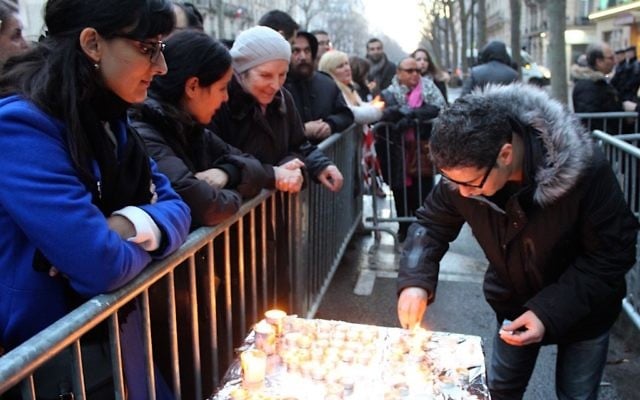 Parmi les participants à la manifestation de ce dimanche 14 février, au 229 boulevard Voltaire, certains agitaient des drapeaux israéliens et d’autres, plus nombreux, tenaient une bougie (Crédit : Times of Israël Staff/Glenn Cloarec)