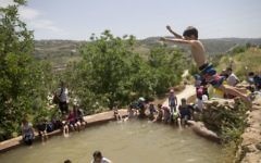 Les Israéliens nagent dans une source naturelle près de Jérusalem pendant Pessah, le 24 avril 2016. (Crédit : Yonatan Sindel/Flash90)
