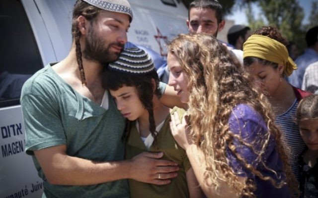 Les enfants du rabbin Miki Mark pendant le service funéraire à la yeshiva d'Otniel, qui était dirigée par leur père, le 3 juillet 2016. (Crédit : Hadas Parush/Flash90) Les enfants du rabbin Miki Mark pendant le service funéraire à la yeshiva d'Otniel, qui était dirigée par leur père, le 3 juillet 2016. (Crédit : Hadas Parush/Flash90)