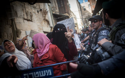 Des musulmanes palestiniennes de l'organisation Murabitun crient des slogans, le Coran à la main, pendant une manifestation contre les policiers israéliens qui les empêchent d'entrer au complexe du mont du Temple de la Vieille Ville de Jérusalem, le 17 septembre 2015. (Crédit : Miriam Alster/Flash90)