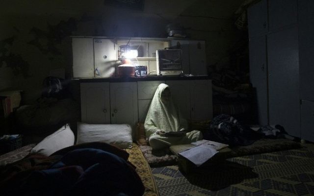Une fillette palestinienne fait ses devoirs pendant une coupure de courant au camp de réfugiés d'Al-Shati, à Gaza ville, le 4 janvier 2017. (Crédit : Mahmud Hams/AFP) Une fillette palestinienne fait ses devoirs pendant une coupure de courant au camp de réfugiés d'Al-Shati, à Gaza ville, le 4 janvier 2017. (Crédit : Mahmud Hams/AFP)