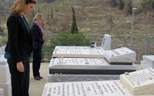 La secrétaire d'Etat chargée de l'aide aux victimes, Juliette Méadel, à gauche, devant la tombe de François-Michel Saada, assassiné à l'Hyper Casher, et l’ambassadrice Hélène Le Gal au cimetière de Givat Shaul, en mars 2017. (Crédit: Elodie Sauvage/Ambassade de France en Israël)