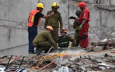 Sauveteurs mexicains et israéliens (en vert olive) à Mexico, le 21 septembre 2017. (Crédit : Ronaldo Schemidt/AFP)