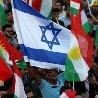 Illustration : Des Kurdes irakiens brandissant un drapeau d'Israël et des drapeaux kurdes lors d'un événement pour inciter les gens à voter lors du référendum pour l'indépendance à Arbil, la capitale de la région autonome kurde au nord de l'Irak, le 16 septembre 2017 (Crédit : Safin Hamed/AFP)