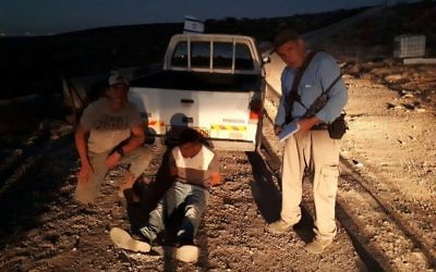 Des fermiers juifs autour d'un Palestinien qui a tenté d'attaquer le propriétaire de la ferme Talia, près de Hébron, en Cisjordanie, le 24 octobre 2017. (Crédit : Conseil régional de Har Hébron)