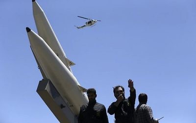 A member of Iranian Revolutionary Guard speaks on his walkie talkie while Zolfaghar surface-to-surface ballistic missiles are displayed in an annual pro-Palestinian rally marking Al-Quds (Jerusalem) Day in Tehran, Iran on June 23, 2017. (AP Photo/Vahid Salemi)