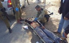 Des soldats de l'armée israélienne s'occupent de Mahmoud Zaal Odeh après qu'il a été blessé par un habitant d'implantation israélien aux abords du village de Qusra le 30 novembre 2017 (Autorisation)