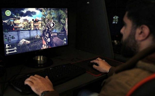 Un Libanais joue à un jeu vidéo créé par le groupe terroriste du Hezbollah appelé "Défense sacrée" dans une banlieue sud de Beyrouth le 27 février 2018. (AFP Photo/Joseph Eid) Un Libanais joue à un jeu vidéo créé par le groupe terroriste du Hezbollah appelé "Défense sacrée" dans une banlieue sud de Beyrouth le 27 février 2018. (AFP Photo/Joseph Eid)