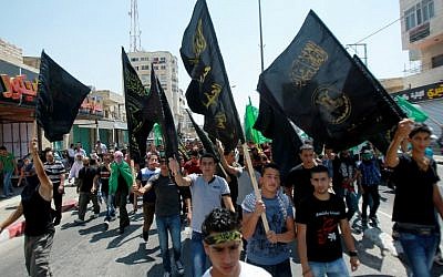 Les partisans palestiniens du Jihad islamique brandissent des drapeaux lors d'un rassemblement pour soutenir les habitants de la bande de Gaza le 15 août 2014 à Bethléem en Cisjordanie (Crédit : AFP / Musa al-Shaer)