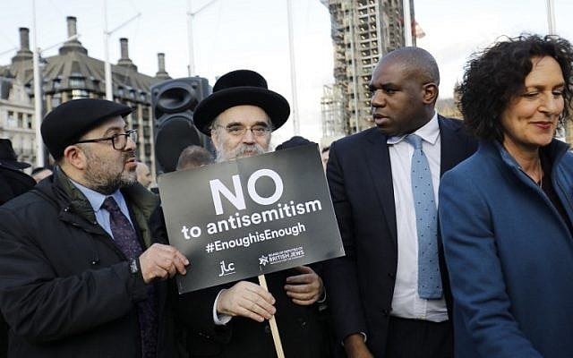 David Lammy (2 à droite), membre du Parti travailliste britannique, se joint aux membres de la communauté juive qui manifestent contre le chef du parti travailliste britannique Jeremy Corbyn et l'antisémitisme au sein du parti travailliste devant les chambres du Parlement britannique dans le centre de Londres le 26 mars 2018 (Crédit : AFP PHOTO / Tolga AKMEN) David Lammy (2 à droite), membre du Parti travailliste britannique, se joint aux membres de la communauté juive qui manifestent contre le chef du parti travailliste britannique Jeremy Corbyn et l'antisémitisme au sein du parti travailliste devant les chambres du Parlement britannique dans le centre de Londres le 26 mars 2018 (Crédit : AFP PHOTO / Tolga AKMEN)