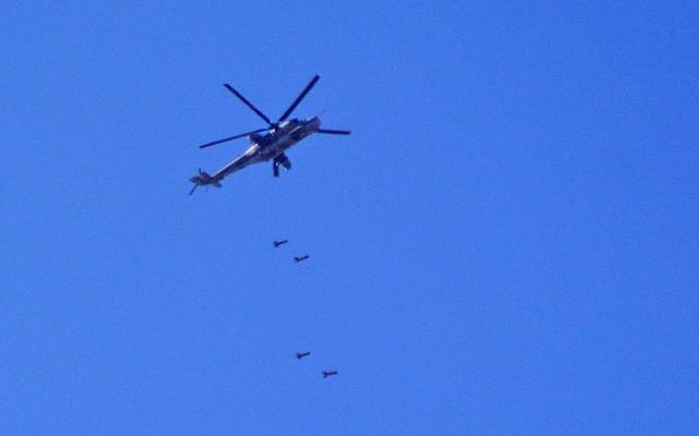 Un hélicoptère MI24 de l'armée syrienne lâche des bombes au dessus de Damas, au niveau de Yarmouk où se trouve un camp de réfugiés palestiniens, le 27 avril 2018. (Crédit : AFP Photo/Rami Al Sayed) Un hélicoptère MI24 de l'armée syrienne lâche des bombes au dessus de Damas, au niveau de Yarmouk où se trouve un camp de réfugiés palestiniens, le 27 avril 2018. (Crédit : AFP Photo/Rami Al Sayed)
