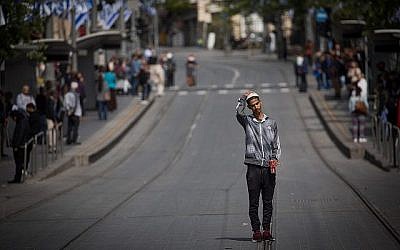 Les gens restent immobiles sur la route de Jaffa, dans le centre de Jérusalem, alors qu'une sirène de deux minutes retentit à travers Israël pour marquer Yom HaShoah, le 12 avril 2018. (Crédit : Yonatan Sindel / Flash90)