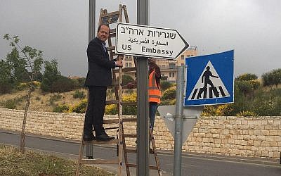 Le maire de Jérusalem Nir Barkat accroche le premier panneau signalant l'ambassade américaine à Jérusalem, le 7 mai 2018 (Crédit : Municipalité de Jérusalem)