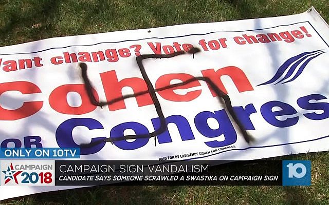 Une affiche de campagne du candidat juif au congrès Lawrence Cohen vandalisée par un dessin de croix gammée, au mois de mai 2018 (Capture d'écran : Ohio Channel 10 News) Une affiche de campagne du candidat juif au congrès Lawrence Cohen vandalisée par un dessin de croix gammée, au mois de mai 2018 (Capture d'écran : Ohio Channel 10 News)