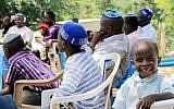 Des membres de la communauté juive ougandaise Abayudaya écoutent leur chef religieux dans un village à côté de Mbale, à l'est de l'Ouganda, le 2 juillet 2016 (Crédit :  AFP/Michael O'Hagan)