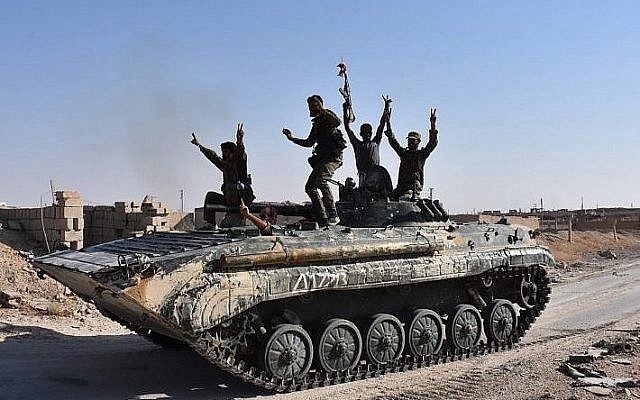 Les forces du gouvernement syrien se réjouissent dans la ville de l'est de la Syrie de Deir Ezzor alors qu'ils continuent à avancer avec l'aide des avions russes dans l'offensive contre l'Etat islamique, le 11 septembre 2017 (Crédit : AFP Photo/George Ourfalian) Les forces du gouvernement syrien se réjouissent dans la ville de l'est de la Syrie de Deir Ezzor alors qu'ils continuent à avancer avec l'aide des avions russes dans l'offensive contre l'Etat islamique, le 11 septembre 2017 (Crédit : AFP Photo/George Ourfalian)