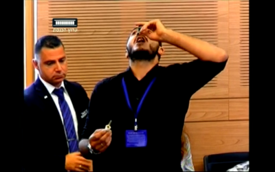Un homme avale une bouteille d'huile de cannabis pendant une réunion de la commission de la Santé à la Knesset (Capture d'écran)