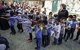 Des enfants rassemblés dans la cour d'une école avant la rentrée scolaire, dans le village de Khan al-Ahmar, en Cisjordanie, le 16 juillet 2018. (Crédit : ABBAS MOMANI/AFP)