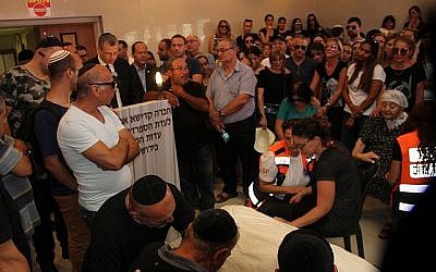 Des amis et des membres de la famille veillent la dépouille de Yotam Ovadia, 31 ans, le 27 juillet 2018. Ovadia a été assassiné près de chez lui dans l'implantation d'Adam lorsqu'un adolescent palestinien l'a poignardé et blessé deux autres Juifs lors d'une attaque terroriste le 26 juillet 2018. (Yonatan Sindel/Flash90)
