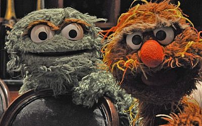 Oscar the Grouch, à gauche, et son cousin israélien Moishe Oofnik lors de l'assemblée génrale des fédérations juives à la Nouvelle Orléans, pour promouvoir l'émission Shalom Sesam, une version israélienne de Sesame Stree, créée pour la chaîne éducative israélienne, en novembre 2010. (Crédit : Daniel Sieradski via JTA)
