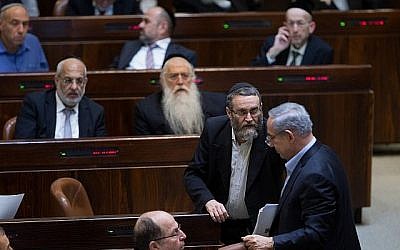 Moshe Gafni, du parti Yahadout HaTorah, s'entretenant avec Benjamin Netanyahu, à la Knesset, le 24 novembre 2015. (Crédit : Yonatan Sindel/Flash90)