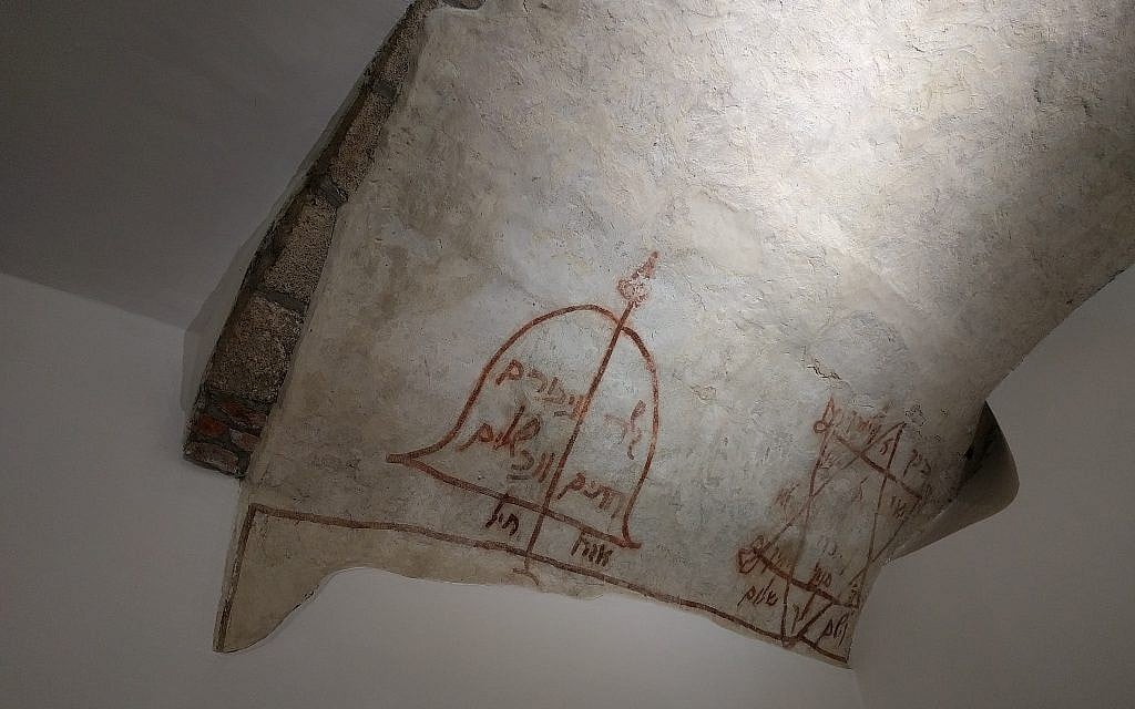 Des inscriptions en hébreu sur le plafond de la synagogue médiévale montrent un arc et une flèche avec une prière pour la paix et une étoile de David avec une bénédiction rabbinique (Crédit : Yaakov Schwartz/ Times of Israel)