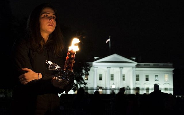 Des membres et des sympathisants de la communauté juive se réunissent pour une veillée en souvenir de ceux qui sont morts plus tôt dans la journée lors d'une fusillade à la synagogue Tree of Life dans le quartier de Squirrel Hill à Pittsburgh, en face de la Maison Blanche à Washington DC le 27 octobre 2018. (Crédit : ANDREW CABALLERO-REYNOLDS / AFP)