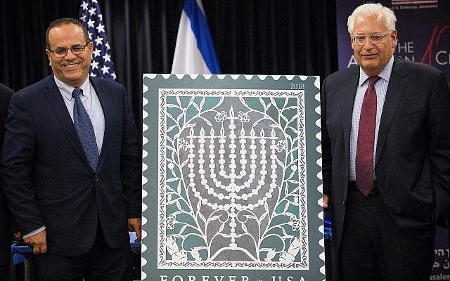 L'ambassadeur américain en Israël David Friedman et le ministre des communications Ayoub Kara lors de la cérémonie de lancement du nouveau timbre pour Hanoukka, marquant les 70 ans de relations diplomatiques entre les États-unis et Israël, le 16 octobre 2018.(Crédit: Yonatan Sindel/FLash90) L'ambassadeur américain en Israël David Friedman et le ministre des communications Ayoub Kara lors de la cérémonie de lancement du nouveau timbre pour Hanoukka, marquant les 70 ans de relations diplomatiques entre les États-unis et Israël, le 16 octobre 2018.(Crédit: Yonatan Sindel/FLash90)