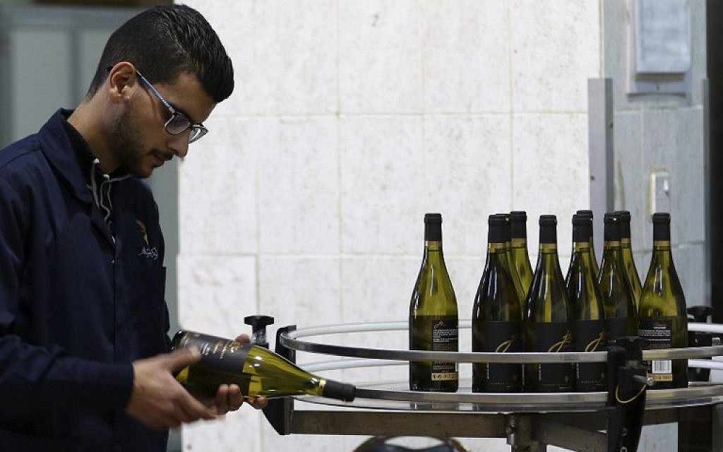 Un employé contrôle la qualité du vin à l'Eagle Distilleries, en Jordanie, le 31 octobre, 2018. (Crédit : KHALIL MAZRAAWI / AFP)