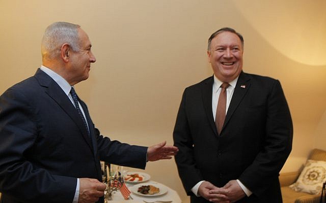 Le Premier ministre Benjamin Netanyahu et le secrétaire d'Etat américain  Mike Pompeo devant une ménorah au second soir de la fête de Hanoukka, au cours de leur rencontre en marge d'une conférence de l'OTAN à Bruxelles, en Belgique, le 13 décembre 2018 (Crédit :  Gaby Farkash/GPO)