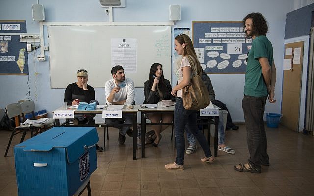 Des Israéliens se préparent à voter dans un bureau de vote à Tel Aviv, pour le 20e Parlement, lors des élections générales israéliennes, le 17 mars 2015. (Danielle Shitrit/FLASH90)