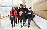 Dieudonné M'bala M'bala, portant un masque représentant un ananas en référence à son expression négationniste 'shoahananas', se dirige vers le palais de justice de Paris le 26 mars 2019, (Crédit : KENZO TRIBOUILLARD / AFP)