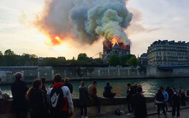 Des Parisiens et des touristes réunis sur les quais de Seine afin d'observer le violent incendie qui a ravagé la cathédrale Notre-Dame de Paris, le 15 avril 2019. (Crédit photo : FOUAD MAGHRANE / AFP)
