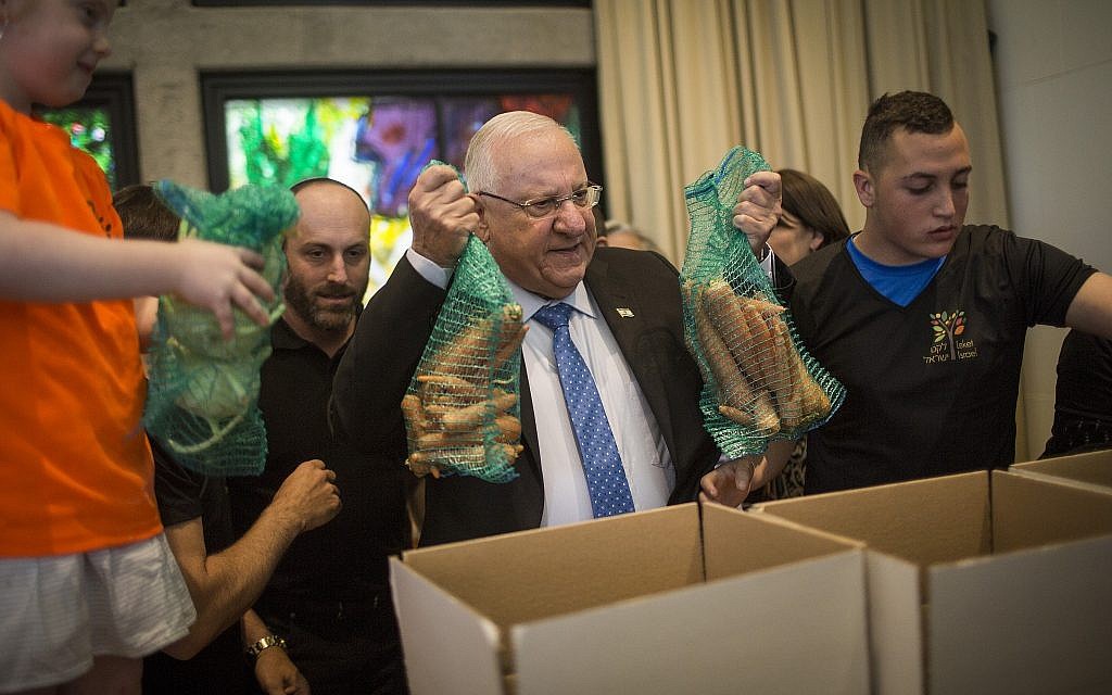 Le Président Reuven RIvlin aide des bénévoles à préparer des colis de nourriture pour les familles nécessiteuses avant Pessah, à la résidence du Président à Jérusalem, le 19 avril 2016. (Hadas Parush/Flash90/Fichier) Le Président Reuven RIvlin aide des bénévoles à préparer des colis de nourriture pour les familles nécessiteuses avant Pessah, à la résidence du Président à Jérusalem, le 19 avril 2016. (Hadas Parush/Flash90/Fichier)