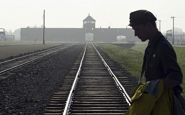 Dans cette photo du 29 juillet 2016, un homme traverse la tristement célèbre voie ferrée de l'ancien camp de la mort nazi d'Auschwitz-Birkenau en Pologne. (AP Photo/Alik Keplicz, FILE) Dans cette photo du 29 juillet 2016, un homme traverse la tristement célèbre voie ferrée de l'ancien camp de la mort nazi d'Auschwitz-Birkenau en Pologne. (AP Photo/Alik Keplicz, FILE)
