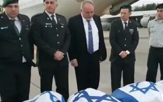 L'ancien ministre de la Défense Avidgor Liberman (au centre) en septembre 2019 avec les cercueils enveloppés dans un drapeau israélien. Des tests ont ensuite révélé qu'il ne s'agissait pas des dépouilles de soldats israéliens portés disparus (Capture d'écran, Douzième chaîne). L'ancien ministre de la Défense Avidgor Liberman (au centre) en septembre 2019 avec les cercueils enveloppés dans un drapeau israélien. Des tests ont ensuite révélé qu'il ne s'agissait pas des dépouilles de soldats israéliens portés disparus (Capture d'écran, Douzième chaîne).