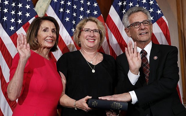 La présidente de la Chambre, Nancy Pelosi, de Californie (à gauche), pose lors d'une cérémonie de prestation de serment avec le représentant démocrate de Californie Alan Lowenthal, (à droite), au Capitole, le jeudi 3 janvier 2019, à Washington, pendant la session inaugurale du 116e Congrès. (AP Photo/Alex Brandon)