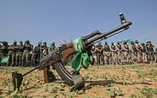 Des combattants des brigades Ezzedine Al-Qassam, aile militaire du groupe terroriste du Hamas, derrière un fusil automatique à Khan Younès, dans le sud de la bande de Gaza, le 11 novembre 2019 (Crédit : Said Khatib/AFP) Des combattants des brigades Ezzedine Al-Qassam, aile militaire du groupe terroriste du Hamas, derrière un fusil automatique à Khan Younès, dans le sud de la bande de Gaza, le 11 novembre 2019 (Crédit : Said Khatib/AFP)
