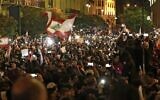 Des manifestants libanais brandissent le drapeau national pendant une manifestation anti-gouvernementale dans le centre-ville de la capitale Beyrouth, le 15 décembre 2019. (Crédit : ANWAR AMRO / AFP)