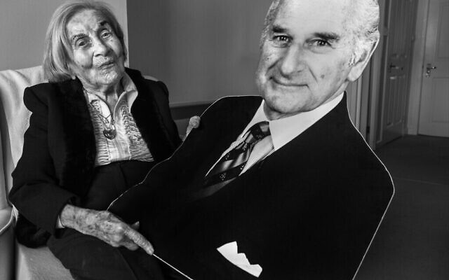 Judith Rosenberg, 93 ans, dans son appartement de Glasgow, en Écosse, tenant un carton découpé de son mari Harold, qui l'a trouvée et l'a libérée d'Auschwitz. (Crédit : Judah Passow/The Lonka Project)