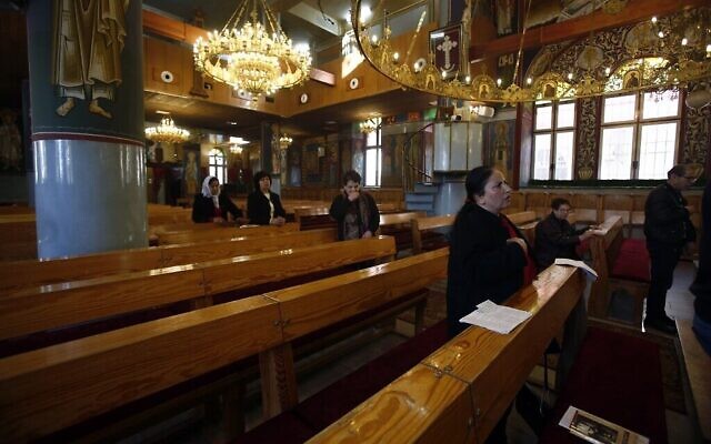 Un petit groupe de fidèles assiste à la messe dans une église orthodoxe de Beit Sahour, près de la ville de Bethléem en Cisjordanie, le 8 mars 2020. (Crédit : Musa Al Shaer/AFP) Un petit groupe de fidèles assiste à la messe dans une église orthodoxe de Beit Sahour, près de la ville de Bethléem en Cisjordanie, le 8 mars 2020. (Crédit : Musa Al Shaer/AFP)
