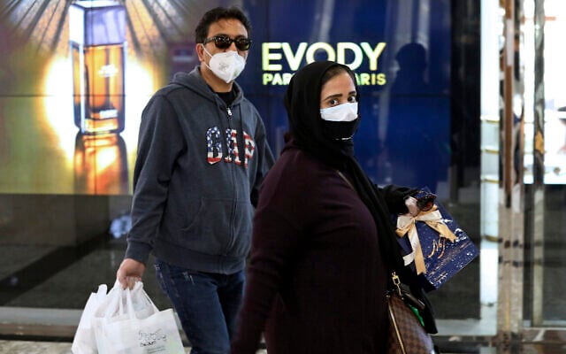 Des gens portent des masques et des gants au centre commercial Palladium dans le nord de Téhéran en Iran, le mardi 3 mars 2020. (AP Photo/Vahid Salemi)
