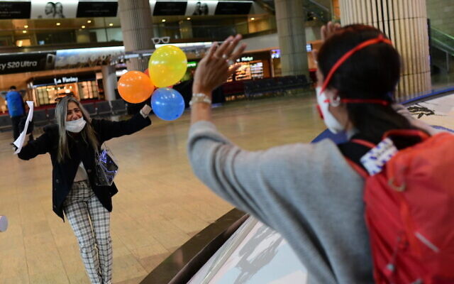 Des passagers israéliens accueillis avec joie à l'aéroport Ben Gurion, le 23 mars 2020 (Crédit : Tomer Neuberg/Flash90) Des passagers israéliens accueillis avec joie à l'aéroport Ben Gurion, le 23 mars 2020 (Crédit : Tomer Neuberg/Flash90)