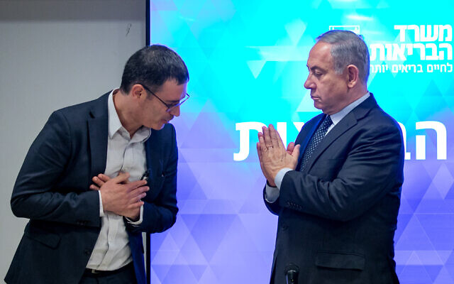 Le Premier ministre Benjamin Netanyahu, à droite, et le directeur-général du ministère de la Santé, Moshe Bar Siman-Tov, lors d'une conférence de presse sur le coronavirus au siège du ministère de la Santé de Jérusalem, le 4 mars 2020 (Crédit : Olivier Fitoussi/ Flash90)