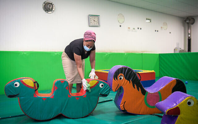 Des employés nettoient une salle de la crèche d'Emunah, dans la ville de Modiin, le 7 mai 2020 (Crédit : Yossi Zeliger/Flash90)