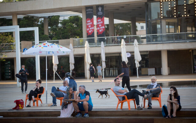 Les Israéliens assis sous des parasols sur la place Habima, aux abords du théâtre national de Tel Aviv, le 26 mai 2020 (Crédit : Miriam Alster/Flash90)