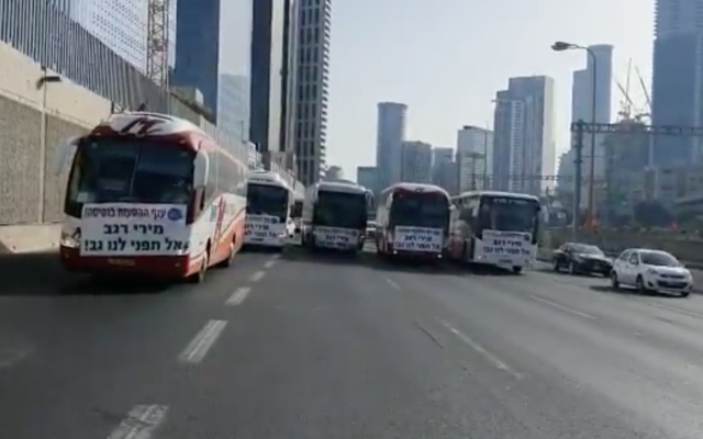 Des compagnies d'autocar privées bloquent l'autoroute Ayalon à Tel Aviv, réclamant l'aide du gouvernement pendant l'épidémie de coronavirus, le 17 juin, 2020. (Capture écran/Twitter) Des compagnies d'autocar privées bloquent l'autoroute Ayalon à Tel Aviv, réclamant l'aide du gouvernement pendant l'épidémie de coronavirus, le 17 juin, 2020. (Capture écran/Twitter)