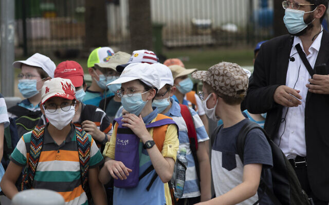 Des écoliers israéliens portent des masques faciaux pour prévenir la propagation du coronavirus, à Tel Aviv, le 6 juillet 2020. (AP Photo/Sebastian Scheiner) Des écoliers israéliens portent des masques faciaux pour prévenir la propagation du coronavirus, à Tel Aviv, le 6 juillet 2020. (AP Photo/Sebastian Scheiner)